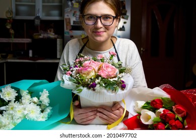 Smiling Florist Woman With Three Different Bouquets Of Flowers. Portrait Of Young Female Florist With Box Of Roses, Red And White Tulips, Daisies Looking At Camera. Home Working. Small Business.