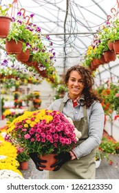 Smiling Florist working in green house
