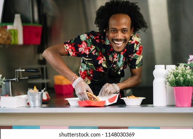 Smiling food vendor hands food to waiting customer - Powered by Shutterstock