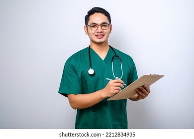 Smiling Friendly Asian Male Physician, Doctor With Clipboard During Daily Checkup, Standing Over Isolated White Background