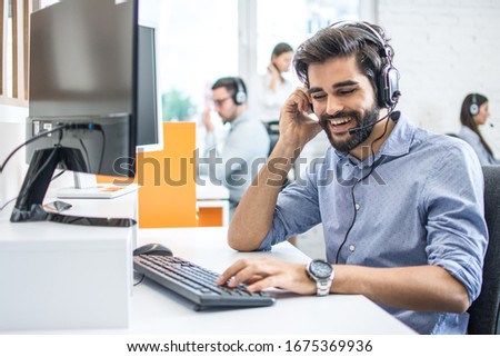 Smiling friendly helpline technical support operator in call centre