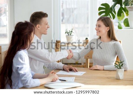 Smiling friendly hr manager handshake applicant welcoming at job interview or hiring successful candidate, satisfied recruiter female seeker shaking hands at meeting, recruitment employment concept