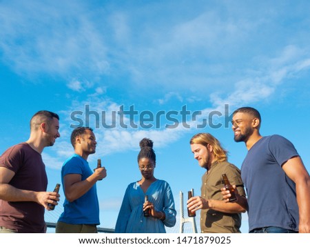 Similar – Multiethnic friends resting outside food truck in evening