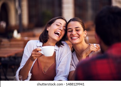 Smiling Friends Drinking Coffee And Laughing