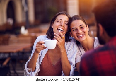 Smiling Friends Drinking Coffee And Laughing