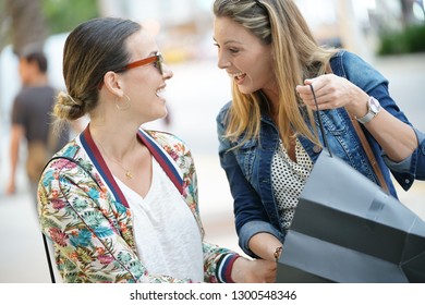 Smiling friends on shopping spree in the city - Shutterstock ID 1300548346
