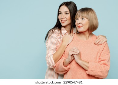 Smiling fun elder parent mom with young adult daughter two women together wear casual clothes look aside on workspace area mock up hugging isolated on plain blue cyan background. Family day concept - Shutterstock ID 2290547481