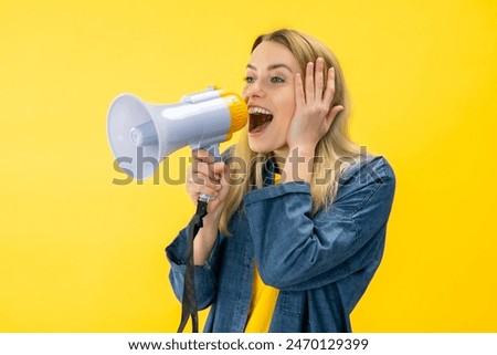 Smiling fun young woman in denim jacket posing isolated on yellow background in studi Scream in megaphone, announces discounts sale