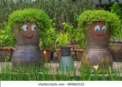 Smiling funny flower pots in a garden.