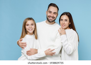 Smiling Funny Young Happy Parents Mom Dad With Child Kid Daughter Teen Girl In Basic White Sweaters Hugging Isolated On Blue Color Background Studio Portrait. Family Day Parenthood Childhood Concept