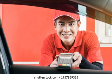 Smiling Gas Station Worker Taking Contactless Credit Card With NFC Technology, Paying For Fuel Using Credit Card Via Payment Terminal At Gas Station