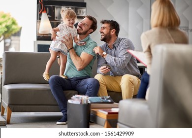   Smiling Gay Couple In Shopping.  Couple Enjoying In Shopping With Child Girl