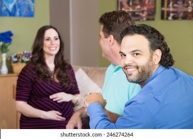 Smiling Gay Man And Partner With Surrogate Mother