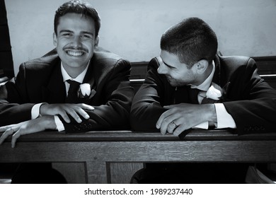 Smiling Gay Men Laugh While Waiting In Church To Be Married.