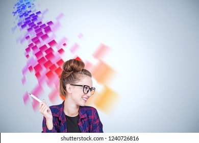 Smiling Geek Girl In Glasses Wearing Checkered Shirt Sitting Near Gray Wall With Red And Purple Flow Of Data Sketch. Mock Up