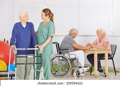 Smiling Geriatric Nurse With Group Of Senior People In A Nursing Home