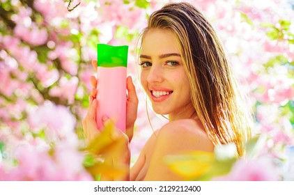 Smiling Girl With Cosmetic For Hair. Shampoo, Conditioner Or Hair Balsam. Organic Haircare Products.