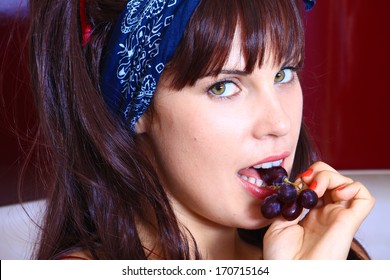 Smiling Girl Eating Grapes