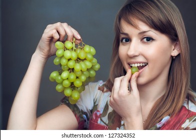 The Smiling Girl Is Eating Green Grapes