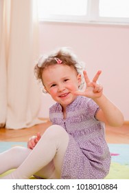 Smiling Girl Holding Up Three Fingers