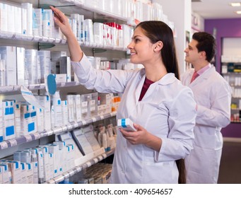 Smiling Girl And Pharmacy Technician Posing In Drugstore