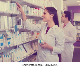 Smiling Girl And Pharmacy Technician Posing In Drugstore