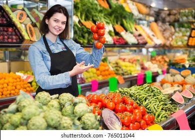 Smiling girl seller is showing assortment of grocery shop.  - Shutterstock ID 765011044