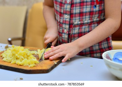 Smiling girl squeezing lemon juice into blender with water and sliced fruit while preparing smoothie - Powered by Shutterstock