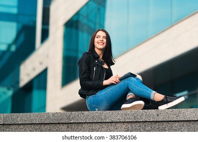 Smiling Girl With Tablet On City Background