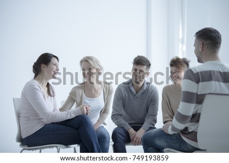 Smiling girl talking about her fight against addiction during meeting with support group