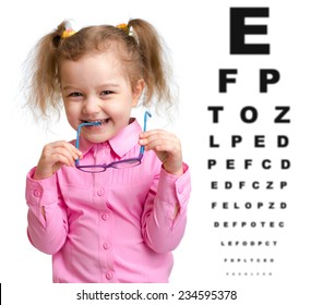 Smiling Girl Took Off Glasses With Blurry Eye Chart Behind Her