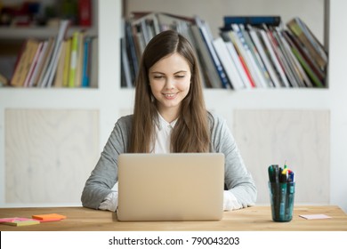 Smiling girl using laptop, student studying at home, digital education, teenager typing on computer browsing web, blogger influencer chatting online in social networks, woman working on pc in office