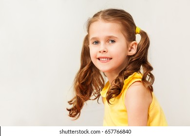 Smiling Girl In Yellow Shirt Looking At Camera Smiling Girl In Yellow Shirt Looking At Camera