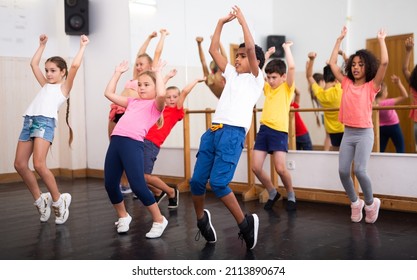 Smiling Girls And Boys Doing Dance Workout During Group Class In Fitness Center