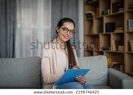 Smiling glad young european female doctor psychologist in glasses in office interior. Medical support, psychological therapy, session with professional, help and new normal during covid-19 pandemic Foto stock © 