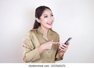 Smiling Government Worker Women Holding And Pointing Screen On Smartphone. PNS Wearing Khaki Uniform.