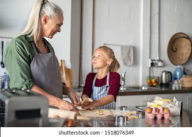 Smiling Grandmother Teaching Granddaughter Make Cookies Stock Photo ...