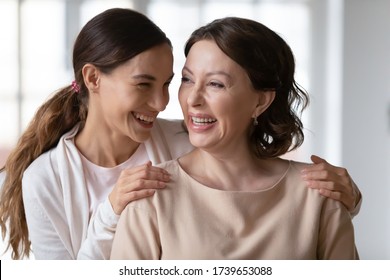 Smiling grateful millennial girl hug cuddle happy middle-aged 60s mother show love and gratitude, happy caring thankful adult grownup daughter embrace mature 50s mom, family bonding, unity concept