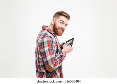 Smiling Greedy Man In Plaid Shirt Putting Money In His Wallet Over White Background