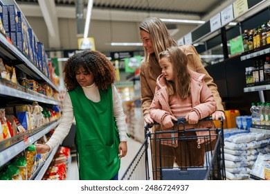 A smiling grocery store worker helps customers while shopping and selecting the groceries they need. - Powered by Shutterstock