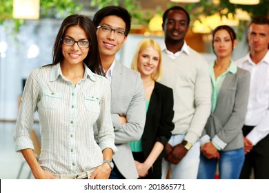 Smiling Group Of Business People In The Office Lined Up