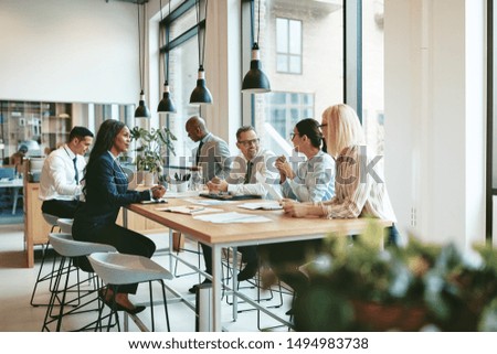 Similar – Image, Stock Photo Business black man in suit leaving the office holding his work briefcase and using smartphone