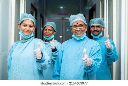 Smiling Group Of Surgeons Showing Thumbs Up While At Hosiptal Corridor After Surgery - Concept Of Successful Treatment, Medical Practitioners And Heatlhcare Professionals