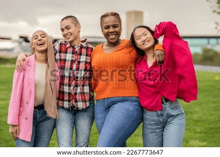 Smiling group of women of different sizes standing together in casual clothes with nature park background. Diverse group of women looking at the camera and laughing. Foto stock © 