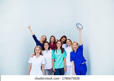 Smiling Group Of Young Medical Students With Mixed-race. A Staff Of Professional Nurses. Advanced Training School