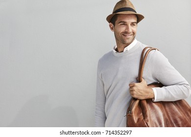 Smiling guy in hat with bag, smiling