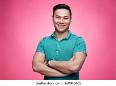 Smiling guy looking at camera on pink background