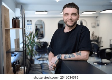 Smiling hairdresser in salon ready to work - Powered by Shutterstock