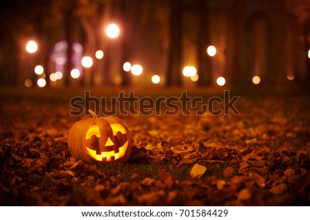 Smiling Halloween Pumpkin in the park at night