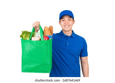 Smiling Handsome Asian Delivery Man Holding Grocery Shopping Bag Isolated On White Background